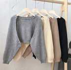 Collection of Korean knitted short cardigans in gray, beige, cream, and black on a clothing rack