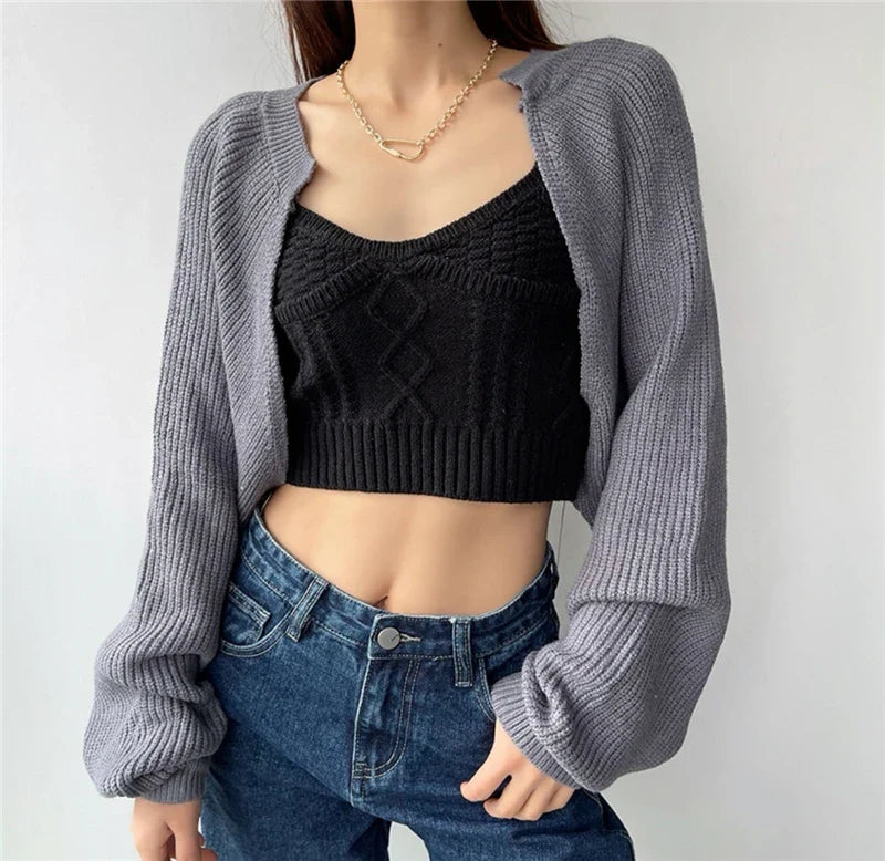 Korean knitted short cardigan in gray, styled over a black crop top with denim jeans