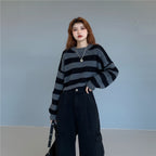 Woman wearing a Korean striped knit sweater in black and gray with wide horizontal stripes