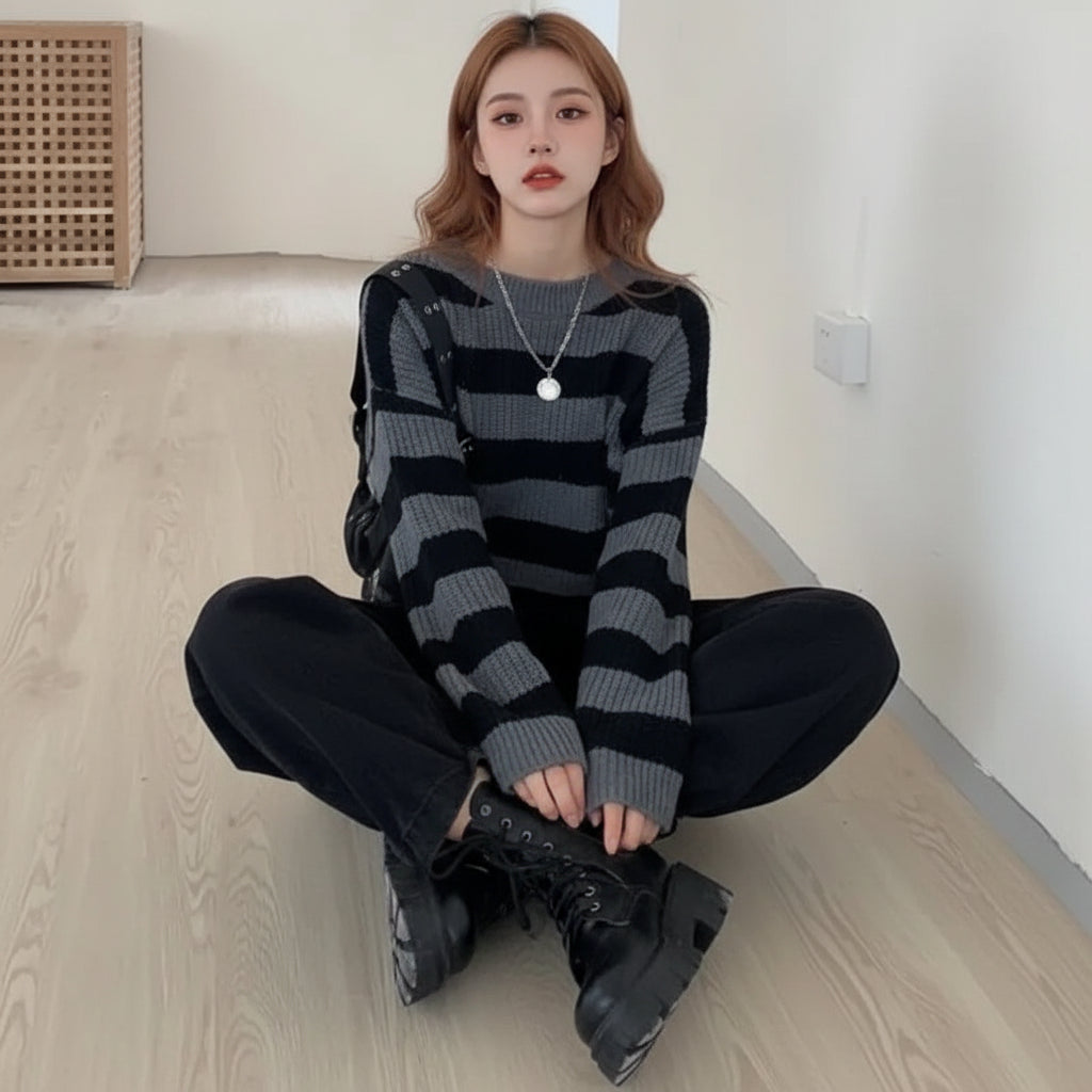 Korean striped knit sweater in gray and black worn with black pants and chunky black boots