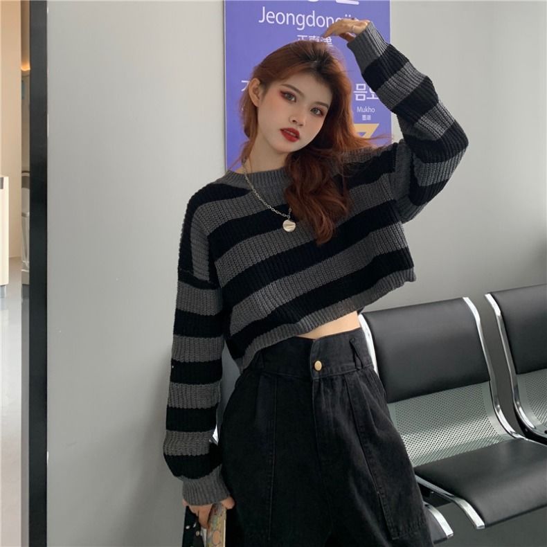 Woman wearing a Korean striped knit sweater in black and gray with long sleeves and cropped fit