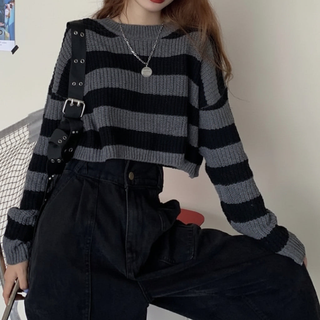 Korean striped knit sweater in black and gray worn with high-waisted black pants and a black strap bag