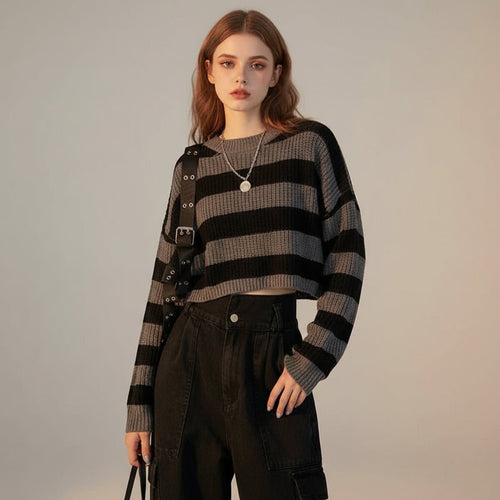 Woman wearing a Korean striped knit sweater in black and gray paired with high-waisted black pants