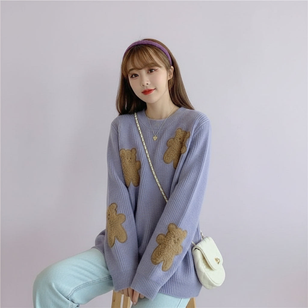 Woman wearing a Korean style loose bear jumper with brown teddy bear patches seated on a sofa