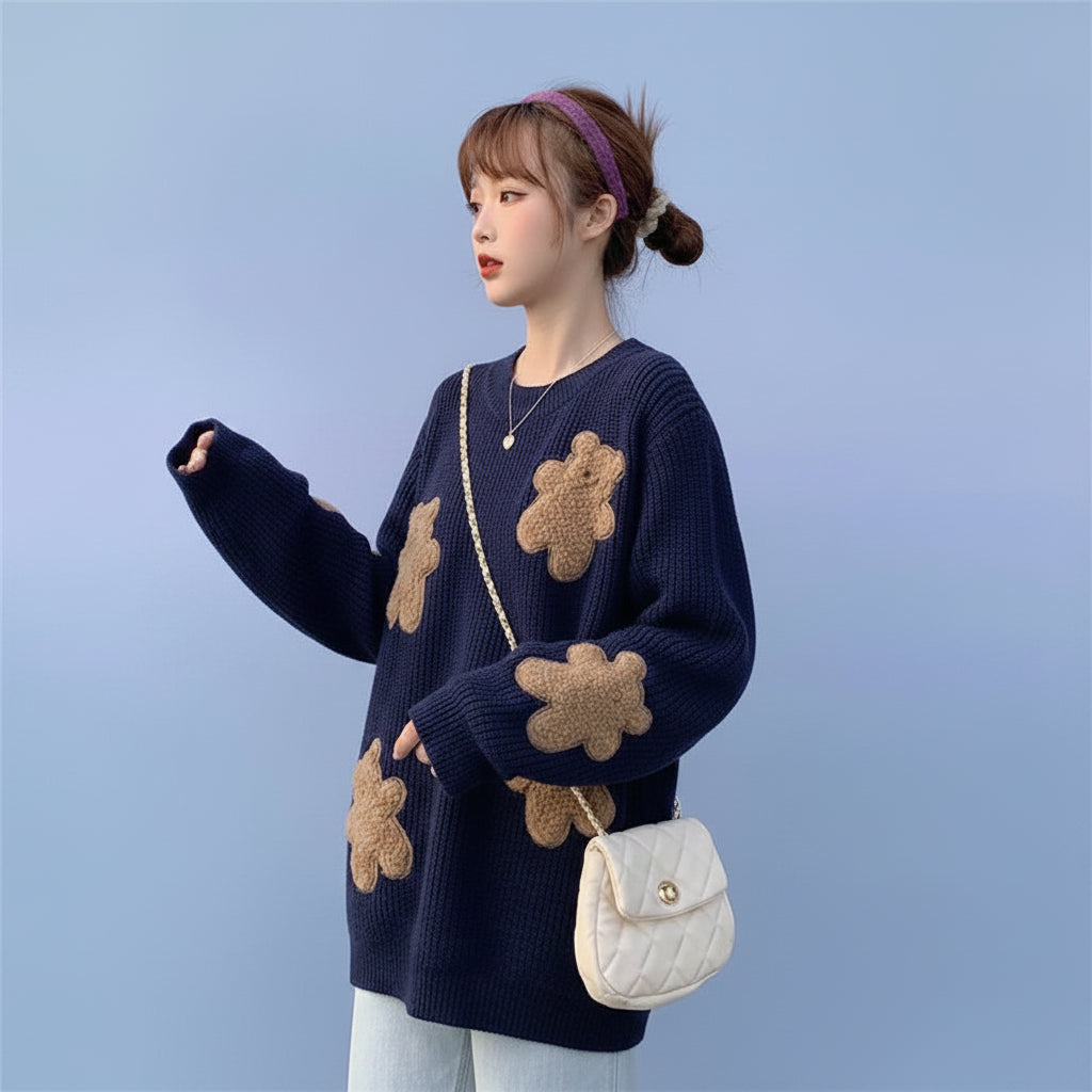 Woman wearing Korean style loose bear jumper in navy with teddy bear patches and white handbag outdoors