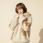 Woman wearing a Korean style loose bear jumper with teddy bear patches and a plush collar outdoors