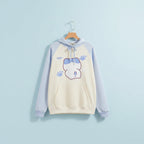 Kuromi print kawaii sweatshirt with light blue sleeves and cream body featuring cute paw prints and character design
