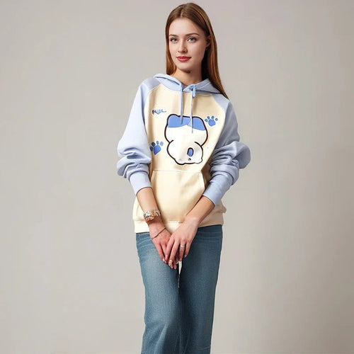 Woman wearing kuromi print kawaii sweatshirt with blue sleeves and cream front featuring a cute character and paw prints