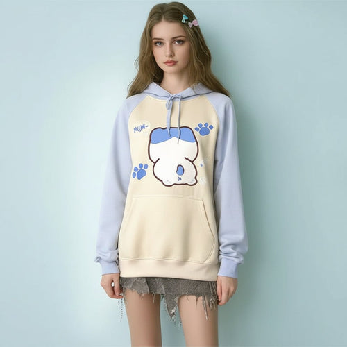 Woman wearing kuromi print kawaii sweatshirt with blue sleeves and beige body featuring cute character and paw prints