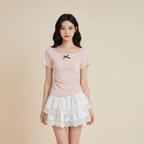 Model wearing kawaii pink bowknot top and white layered skirt
