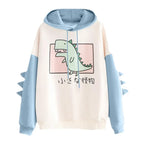 Kawaii dinosaur sweatshirt in white and blue with dinosaur graphic and sleeve spikes