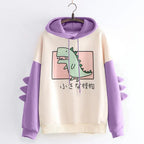 Kawaii dinosaur sweatshirt with purple sleeves and hood featuring a cute green dinosaur graphic