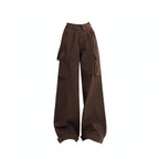 Black distressed sweatshirt layered over yellow plaid flannel with brown cargo pants, wide-leg cargo pockets
