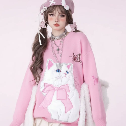 Pink fuzzy cat style oversized sweater with white cat design and bow worn by model with braided hair