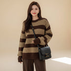 Plus size casual spring sweater with brown and beige stripes worn with a black shoulder bag