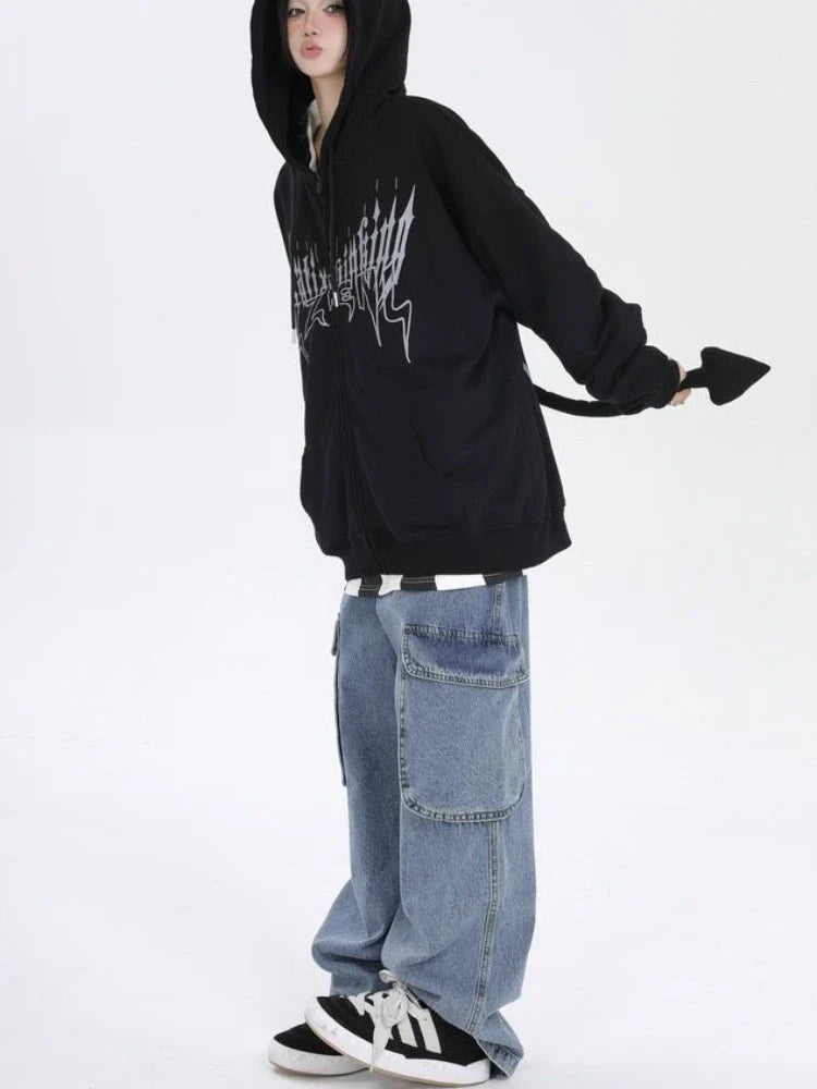 Trendy anime streetwear hoodie in black with graphic print, worn with baggy jeans and sneakers