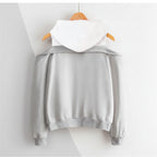 Gray and white strapless hooded sweatshirt for women with long sleeves hanging on wooden hanger