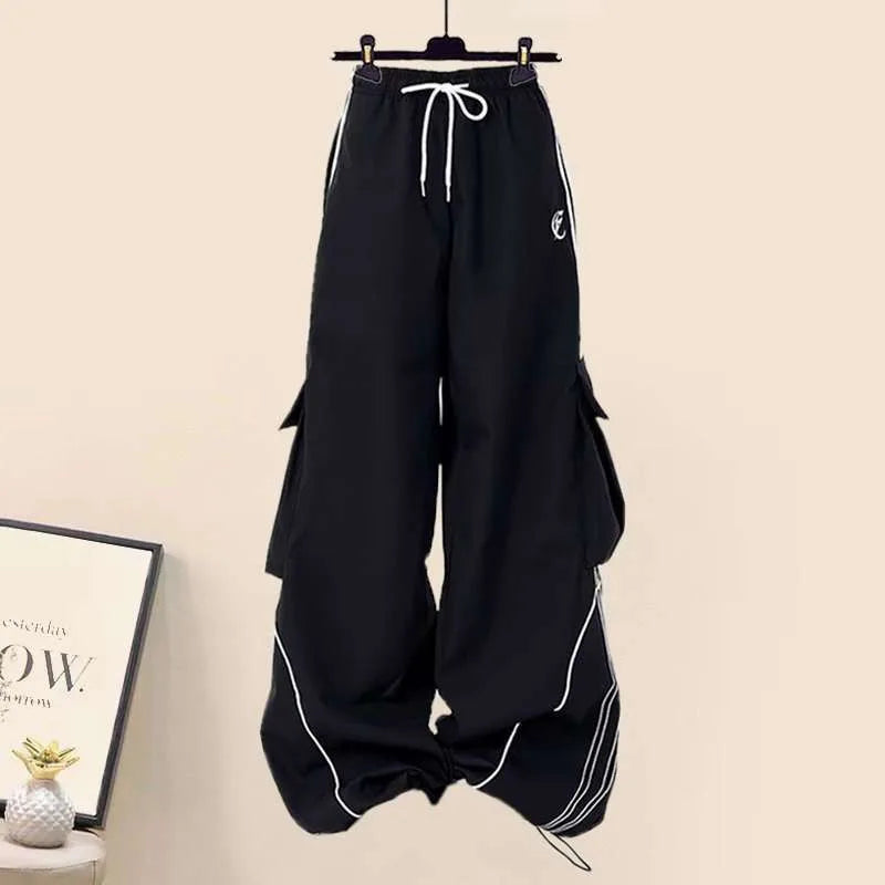 Black wide leg pants with drawstring and white piping from three piece streetwear set for women