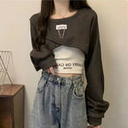 Casual three piece streetwear set for women with cropped black long-sleeve top and light denim jeans