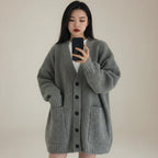 V-neck pullover sweater for women in soft gray with button front and side pockets