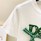 White bowknot t shirt and split midi skirt outfit featuring a green checkered bow on white fabric