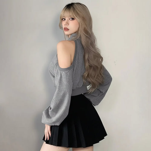 Woman wearing a cute Korean style streetwear top with cold shoulder cutouts and balloon sleeves