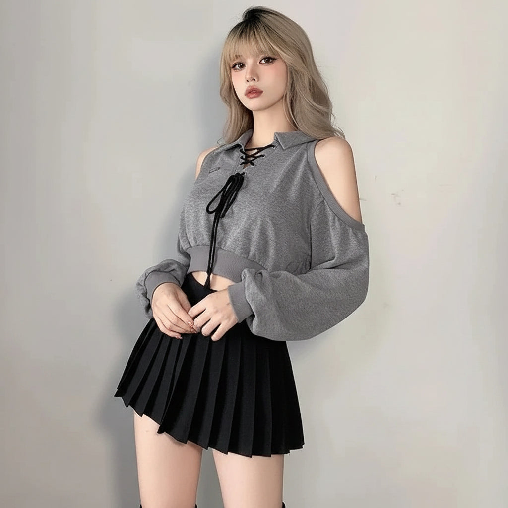 Young woman wearing a cute Korean style streetwear top with cold shoulder and lace-up front in gray