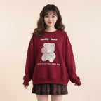 Cute red bear o-neck hoodie Japanese style with teddy bear graphic and text worn with plaid skirt