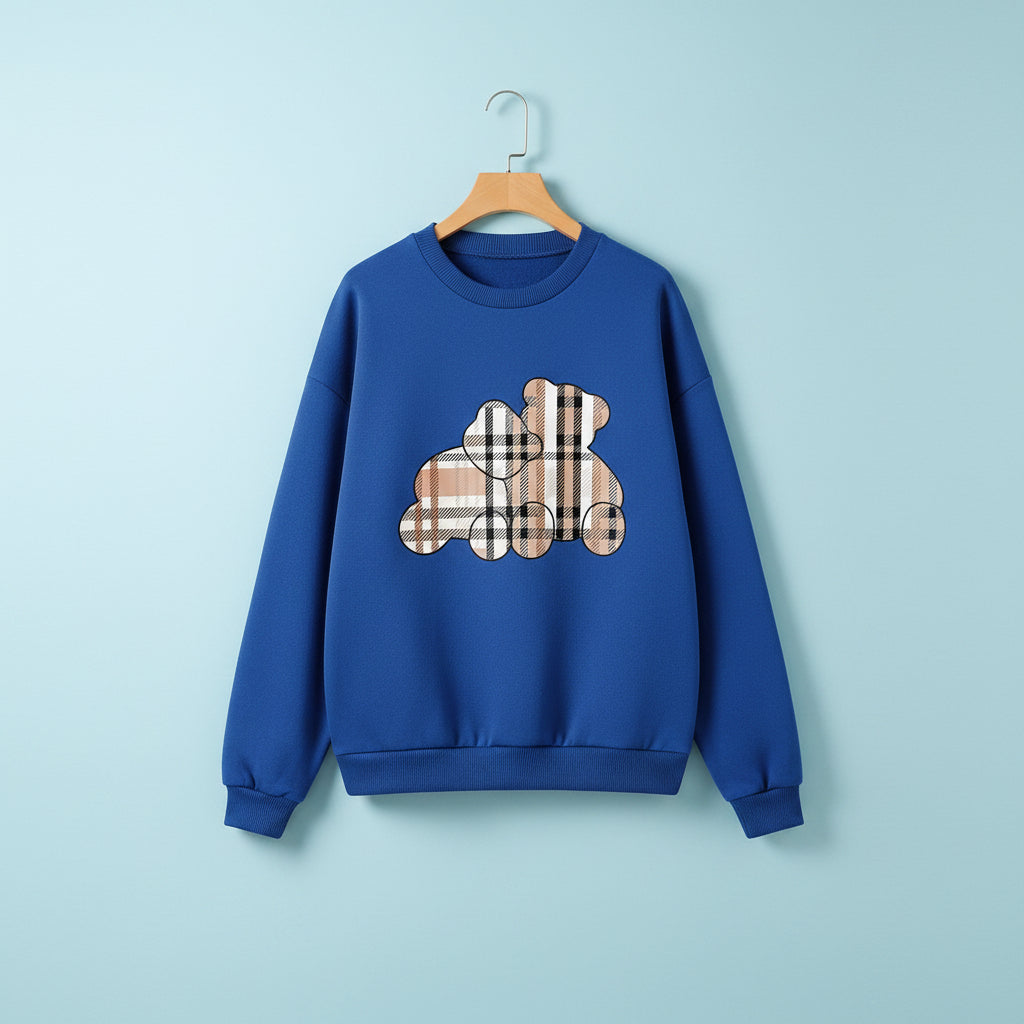 Blue cute teddy print pullover hoodie with a plaid teddy bear graphic laid flat with white sneakers