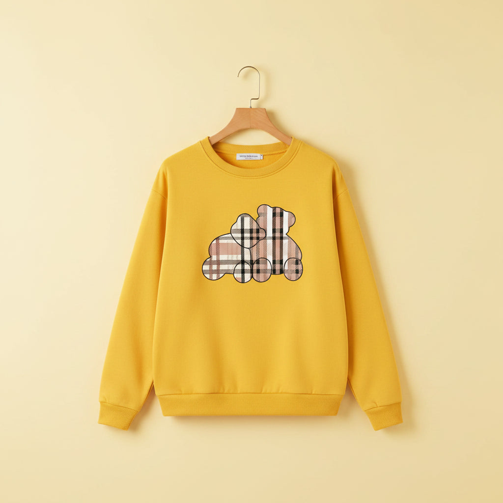 Yellow cute teddy print pullover hoodie with plaid teddy design laid flat on white background
