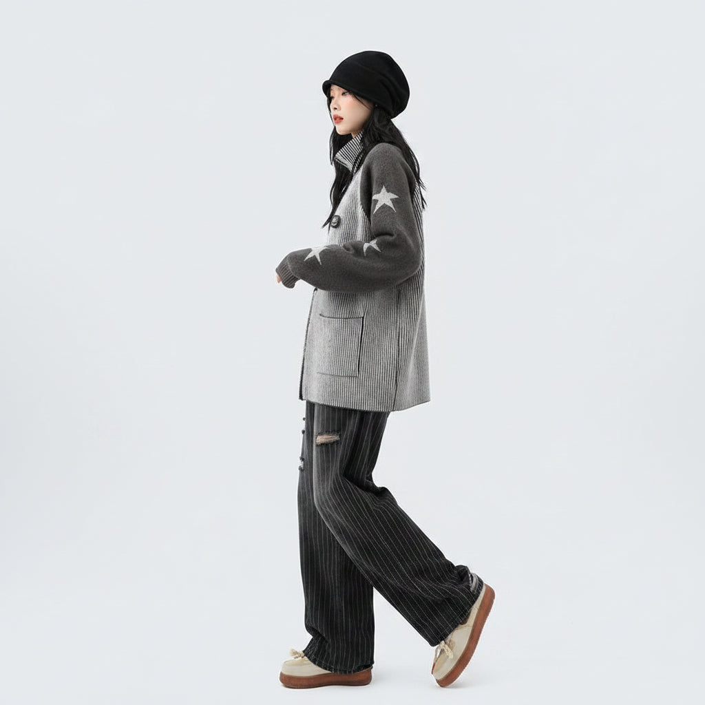 Woman wearing a double zipper autumn jacket for women with star patterns on sleeves paired with striped pants and beige shoes