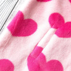 Close-up of pink harajuku heart print plush jacket with vibrant red hearts and soft fuzzy texture