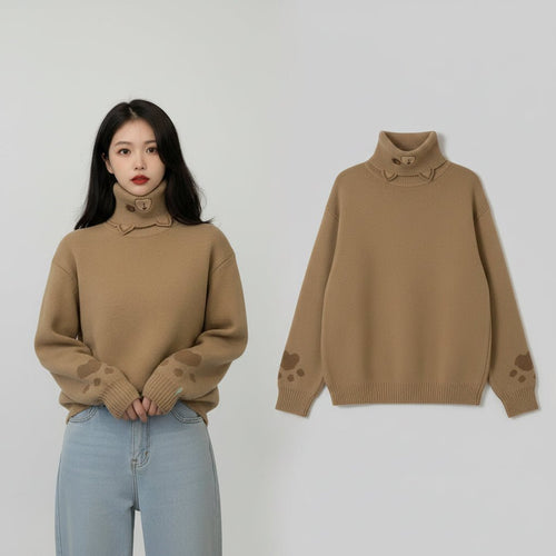 Woman wearing beige japanese cartoon cat pullover for women with paw prints on sleeves and high neck