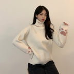 Japanese cartoon cat pullover for women in white with pink paw prints on sleeves worn by woman