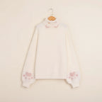Creamy white japanese cartoon cat pullover for women with pink paw prints on sleeves and high neck