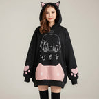 Black japanese cartoon print women sweatshirt with cat ears hood and pink paw detail on sleeve