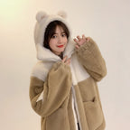 Young woman wearing a japanese cute teddy bear hoodie jacket with bear ears and fuzzy texture