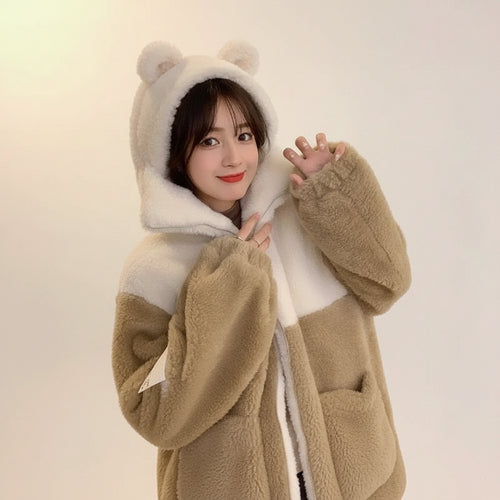 Young woman wearing a japanese cute teddy bear hoodie jacket with bear ears and fuzzy texture