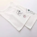 Close-up of white japanese soft girlcat style hoodie sleeves with cute cat tail and paw print designs