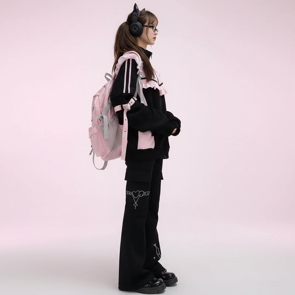 Kawaii cat ear hoodie for women with ears in black and pink worn with matching black pants and a pink backpack