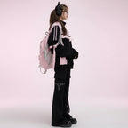Kawaii cat ear hoodie for women with ears in black and pink worn with matching black pants and a pink backpack