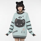 Woman wearing a kawaii cat sweater for women with black cat design and striped sleeves