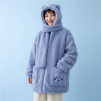 Woman wearing a light blue kawaii fluffy jacket for women with hood and scarf featuring bear face pockets