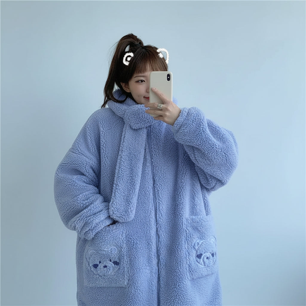 Woman wearing a light blue kawaii fluffy jacket for women with bear pocket details taking a selfie