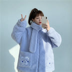 Woman wearing a light blue kawaii fluffy jacket for women with bear face pockets taking a mirror selfie