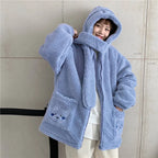 Woman wearing a blue kawaii fluffy jacket for women with hood and bear embroidery on pockets