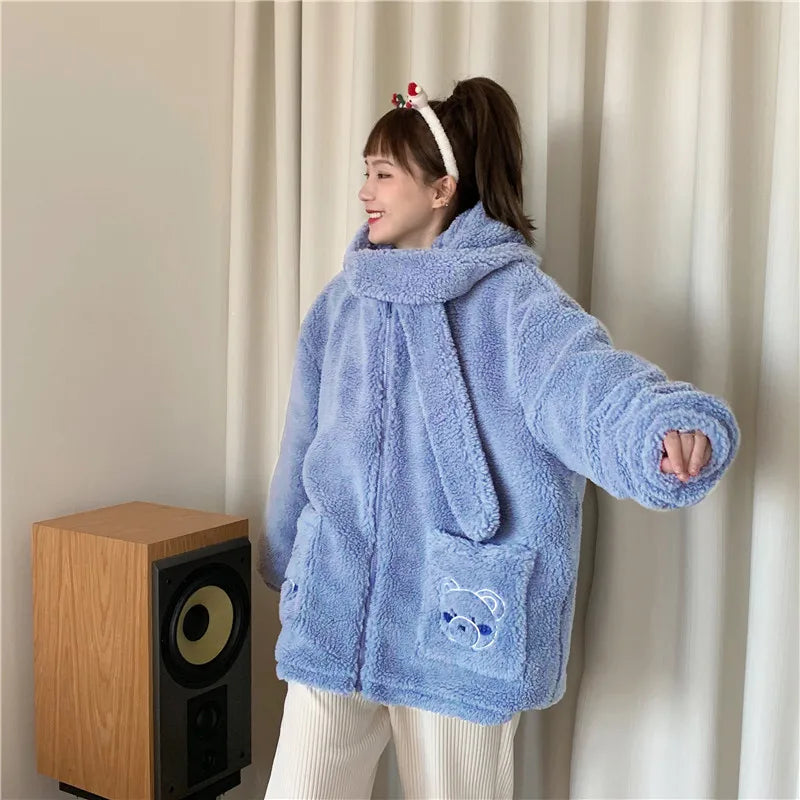 Woman wearing a light blue kawaii fluffy jacket for women with bear pocket design and matching scarf