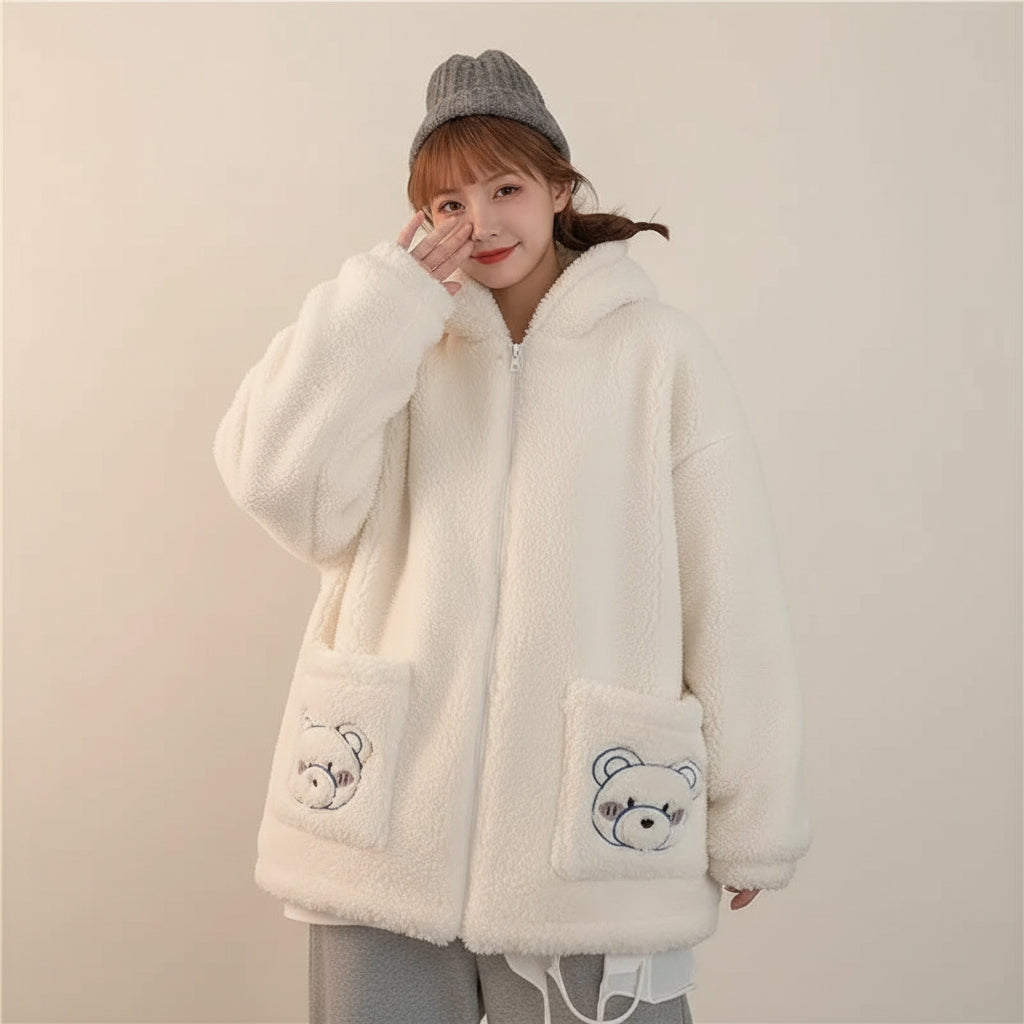 Woman wearing a cozy white kawaii fluffy jacket for women with bear embroidery on pockets
