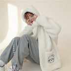 Kawaii fluffy jacket for women in white with hood and bear embroidery worn by seated woman