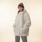 Kawaii fluffy jacket for women in white with bear patch pockets worn by a seated woman